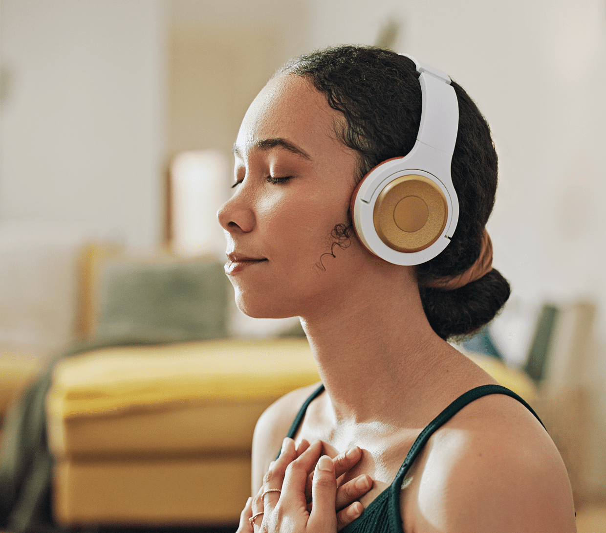 Relaxed woman enjoying music indoors